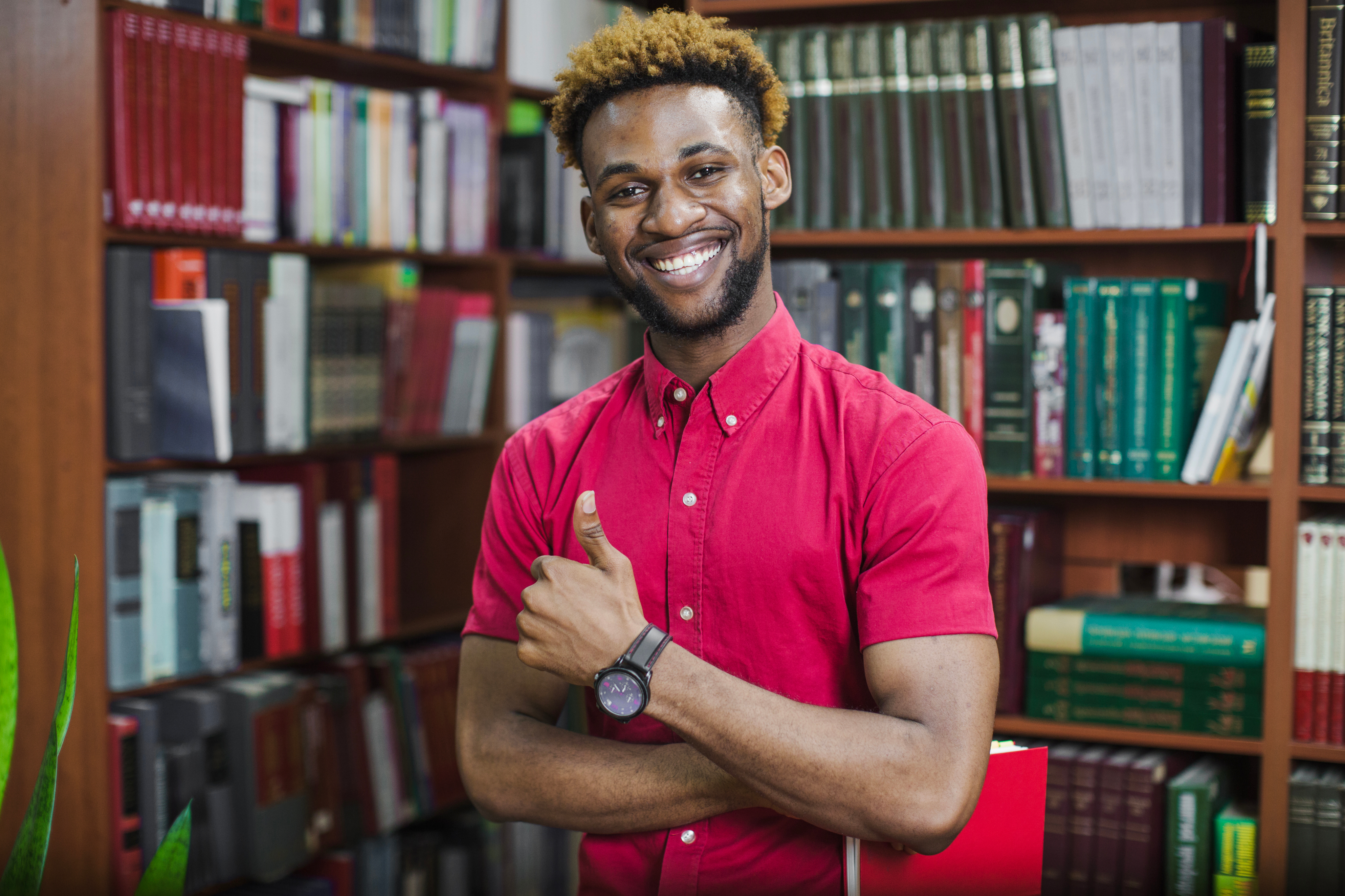 Smiling male tutor in library